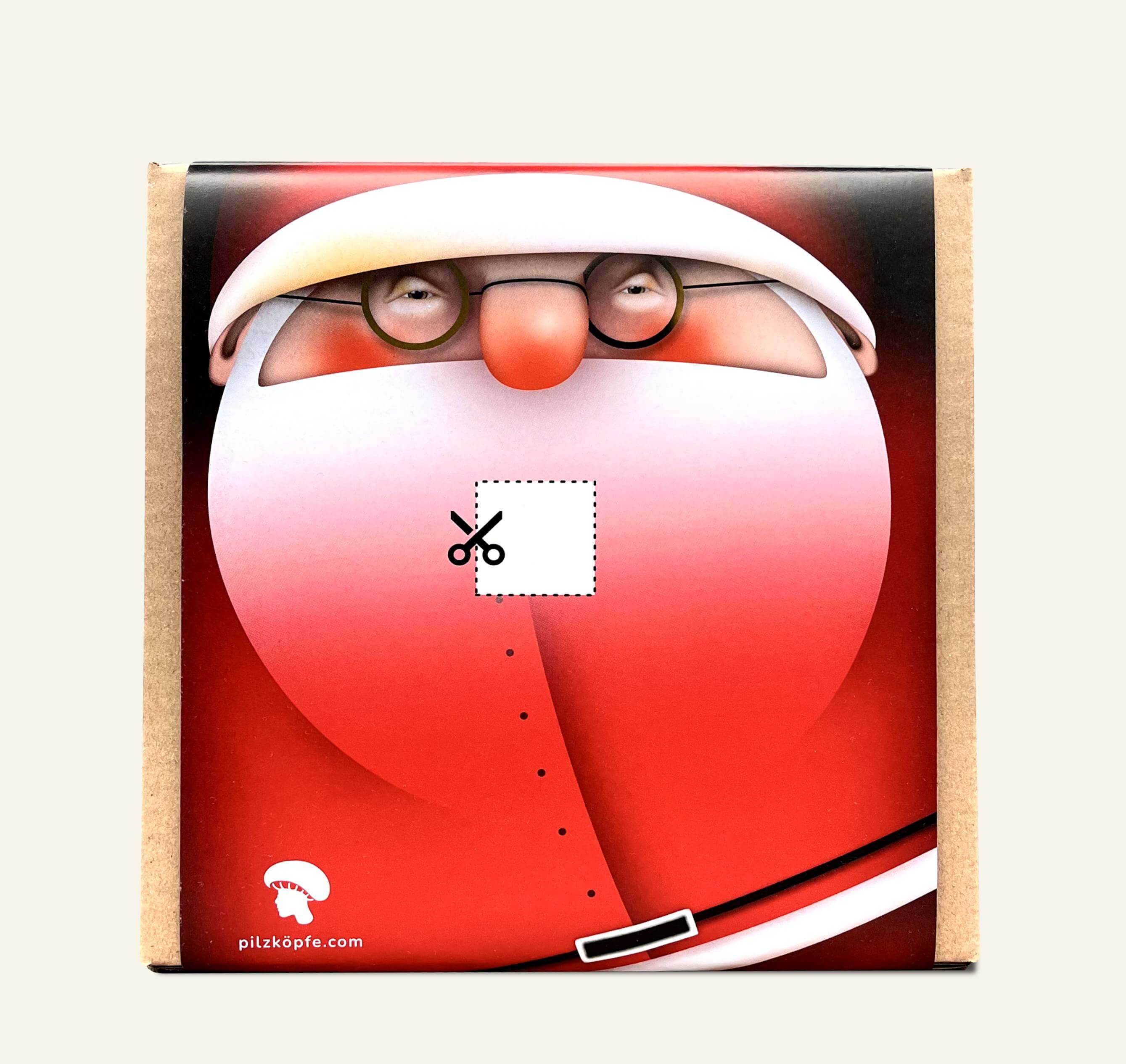 Pilz-Zucht-Set von Pilzköpfe mit Nikolaus-Portrait. Sein Bart ist nur angedeutet und eine rechteckige, weisse Markierung zeigt wie der Karton eingeschnitten werden muss um die Pilz-Zucht zu starten.